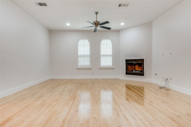 3907 Cole Ave Unit 5, Dallas, TX 75204 - unfurnished living room with a fireplace, light wood-type flooring, visible vents, and ceiling fan