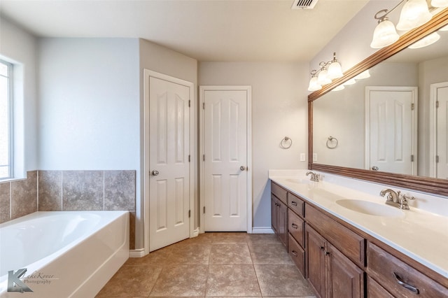 7018 Waterway Ln, Abilene, TX 79606 - full bath with double vanity, a garden tub, tile patterned floors, and a sink