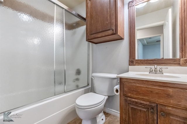 7018 Waterway Ln, Abilene, TX 79606 - full bathroom featuring tile patterned flooring, enclosed tub / shower combo, toilet, vanity, and baseboards