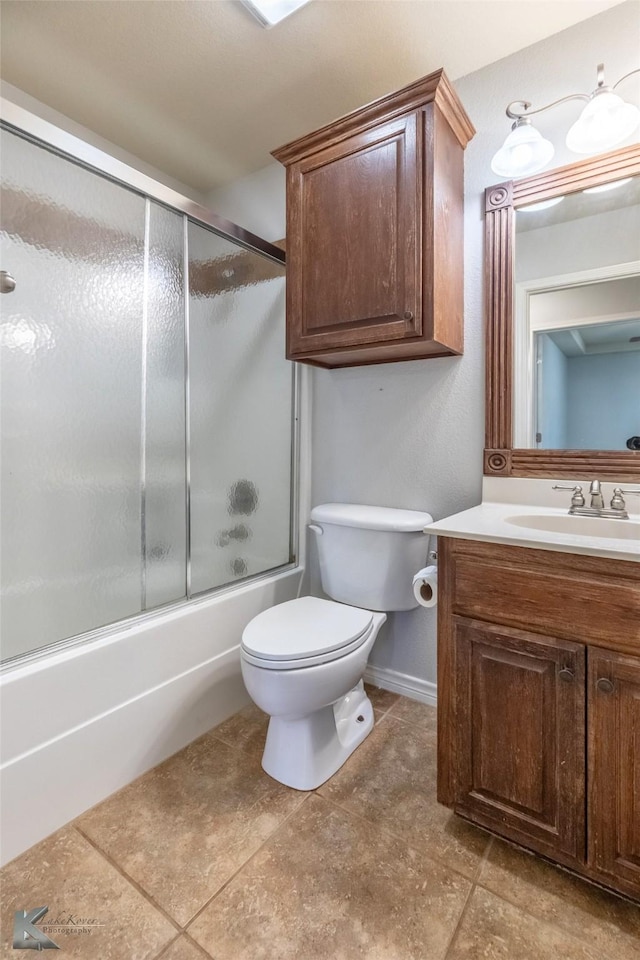 7018 Waterway Ln, Abilene, TX 79606 - bathroom featuring toilet, baseboards, tile patterned flooring, vanity, and enclosed tub / shower combo