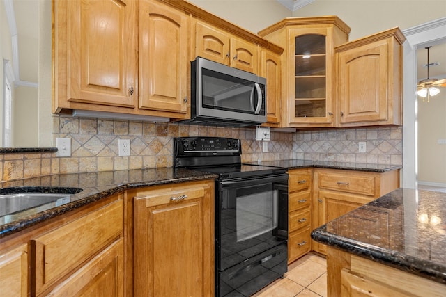 110 Bob White Cir, Lorena, TX 76655 - kitchen with stainless steel microwave, dark stone countertops, ornamental molding, and black electric range