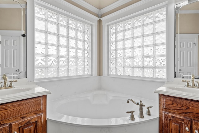 110 Bob White Cir, Lorena, TX 76655 - bathroom featuring two vanities, a garden tub, crown molding, and a sink
