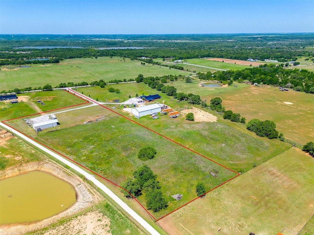drone / aerial view featuring a water view and a rural view