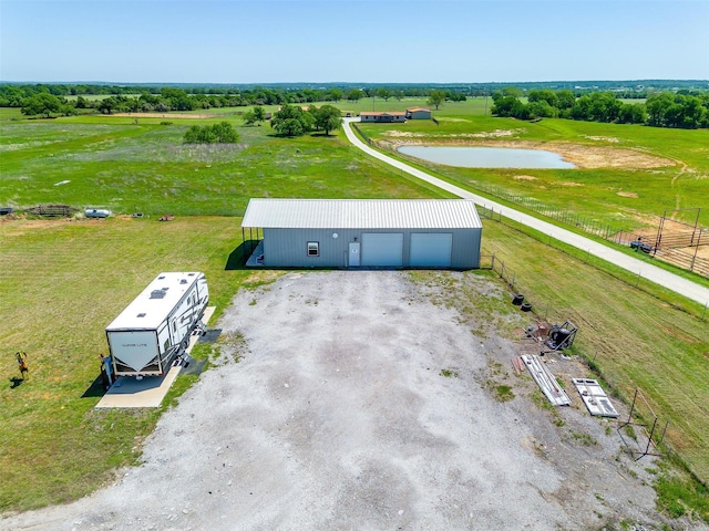 birds eye view of property featuring a water view and a rural view