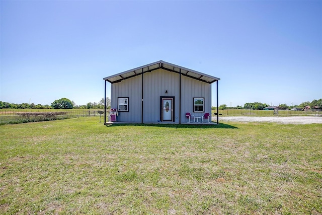 view of outbuilding featuring fence and a rural view
