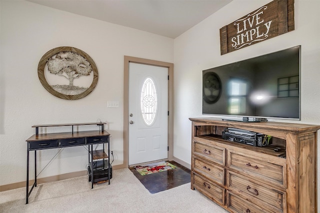 entryway with baseboards and carpet floors