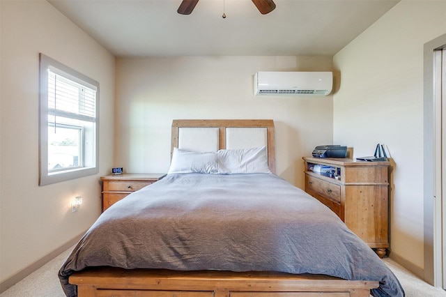 bedroom featuring baseboards, light colored carpet, a wall unit AC, and ceiling fan