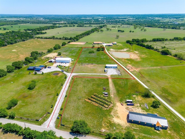 birds eye view of property with a rural view