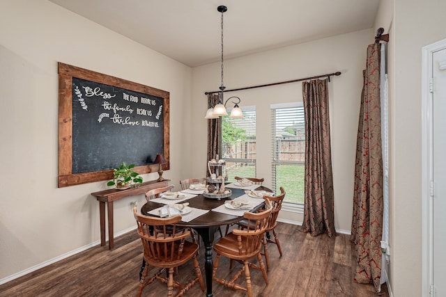 dining space featuring wood finished floors and baseboards