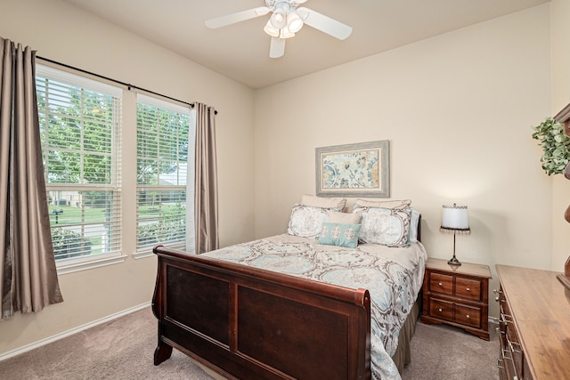 carpeted bedroom with a ceiling fan and baseboards