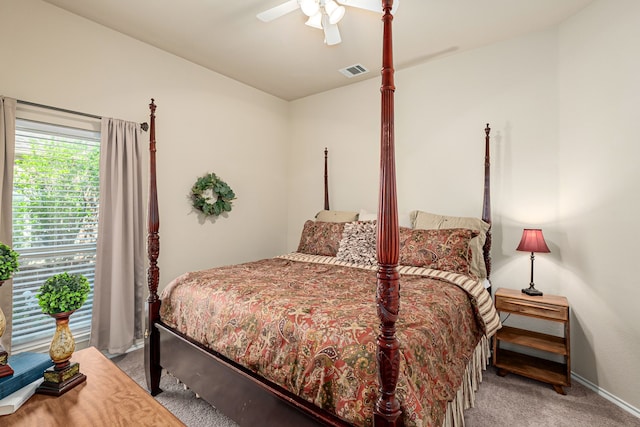 carpeted bedroom featuring baseboards, a ceiling fan, and visible vents