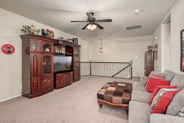 living room with baseboards, a ceiling fan, visible vents, and carpet floors