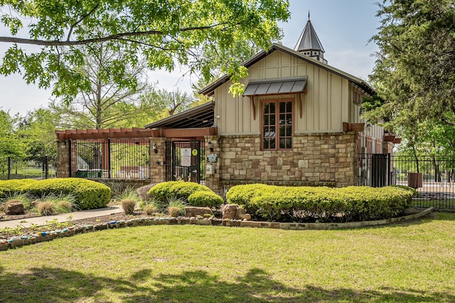 view of front of property with board and batten siding, a front yard, fence, and stone siding
