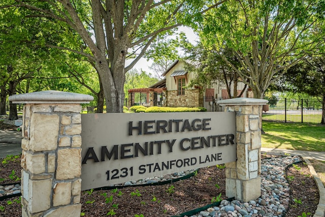 community / neighborhood sign featuring fence