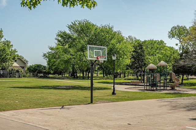 view of basketball court with a lawn, community basketball court, and playground community