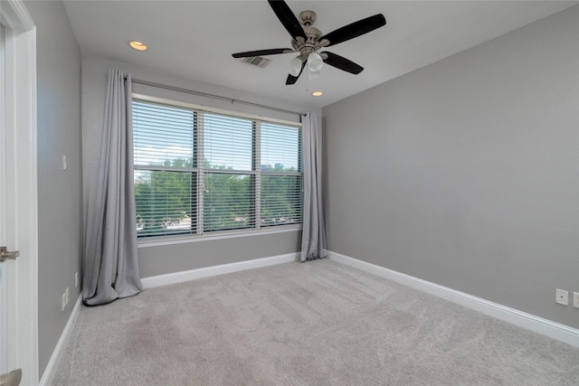 carpeted spare room featuring recessed lighting, visible vents, a ceiling fan, and baseboards