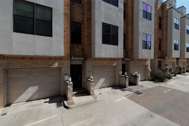 view of property featuring a garage and driveway