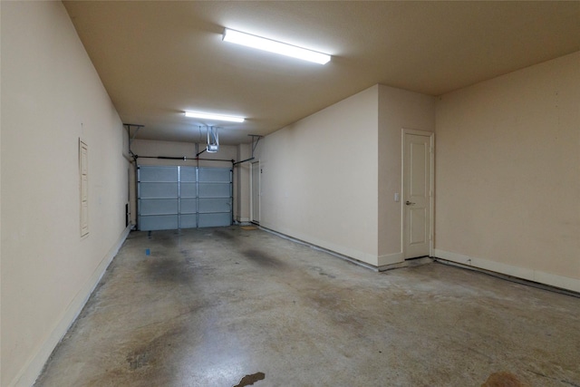 garage with baseboards and a garage door opener