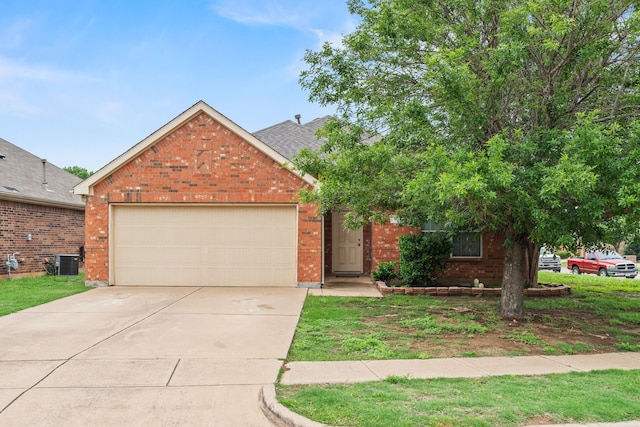 traditional-style home with brick siding, an attached garage, driveway, and cooling unit