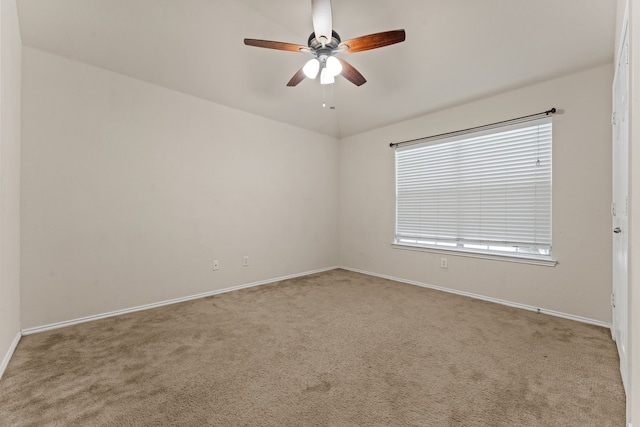 spare room featuring baseboards, carpet, and a ceiling fan