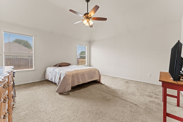 carpeted bedroom featuring baseboards, ceiling fan, and vaulted ceiling
