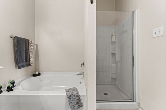 bathroom with a garden tub and a shower stall