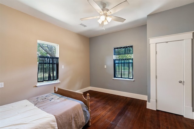 479 County Road 27450, Honey Grove, TX 75477 - bedroom with baseboards, visible vents, a closet, ceiling fan, and hardwood / wood-style floors