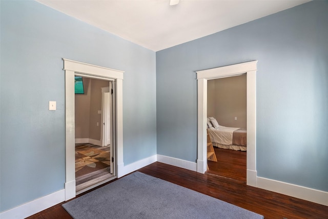 479 County Road 27450, Honey Grove, TX 75477 - unfurnished room with baseboards and dark wood-style flooring