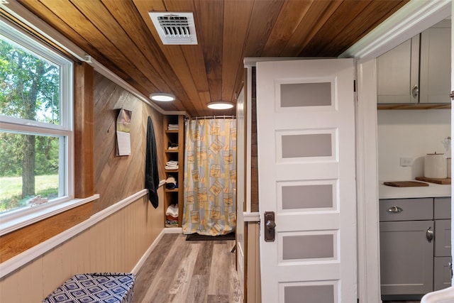 479 County Road 27450, Honey Grove, TX 75477 - interior space with wood walls, wooden ceiling, visible vents, and light wood-style flooring