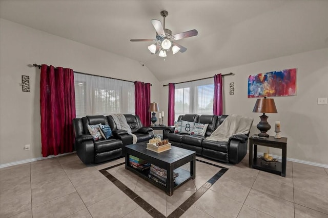 living room with baseboards, ceiling fan, light tile patterned floors, and vaulted ceiling