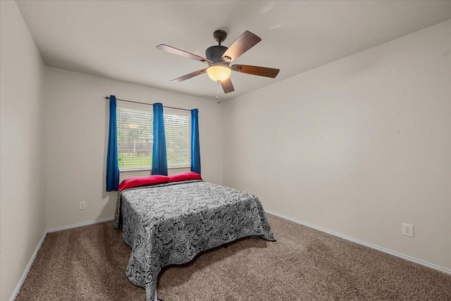 bedroom with a ceiling fan, baseboards, and carpet