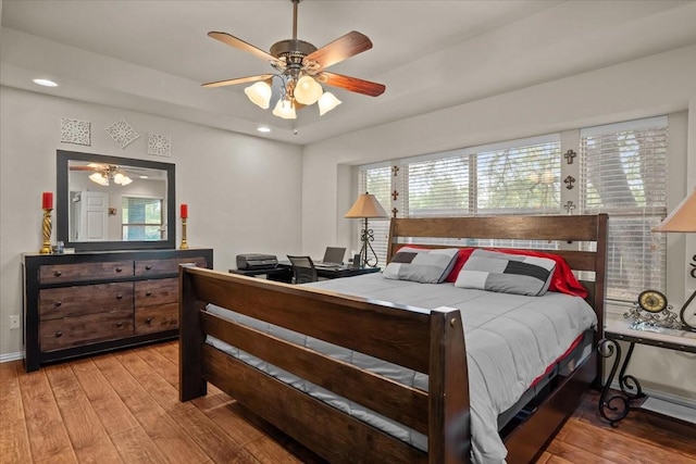 bedroom featuring recessed lighting, multiple windows, and wood finished floors