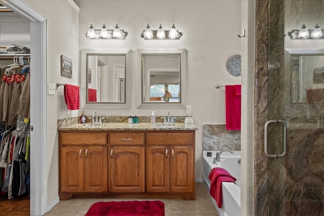 full bath featuring a sink, tile patterned flooring, a stall shower, and a bath