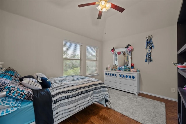 bedroom with baseboards, ceiling fan, high vaulted ceiling, and wood finished floors