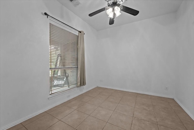spare room featuring visible vents, baseboards, ceiling fan, and light tile patterned floors