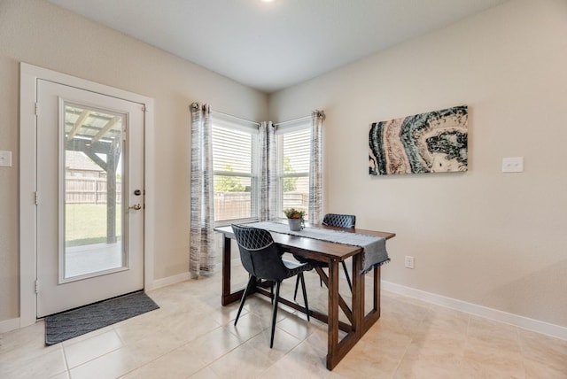 dining room with baseboards and light tile patterned floors
