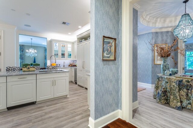 full bathroom with crown molding, wood finished floors, a chandelier, and wallpapered walls