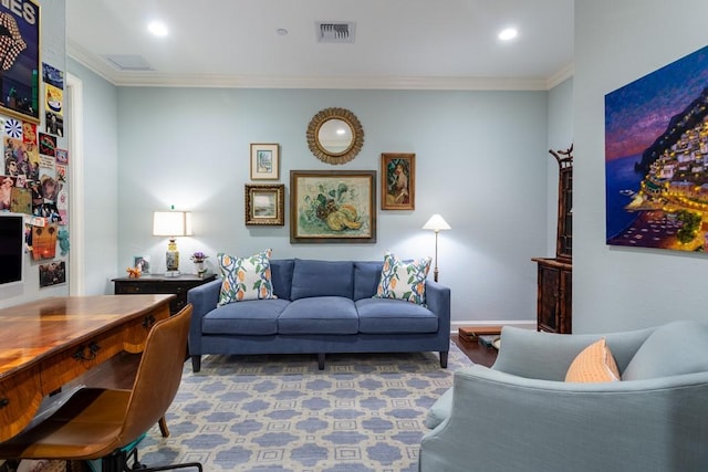 living area with baseboards, wood finished floors, visible vents, and crown molding