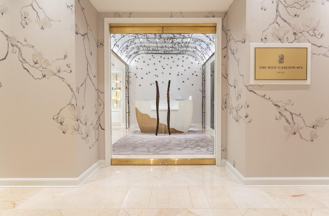 doorway to outside with baseboards