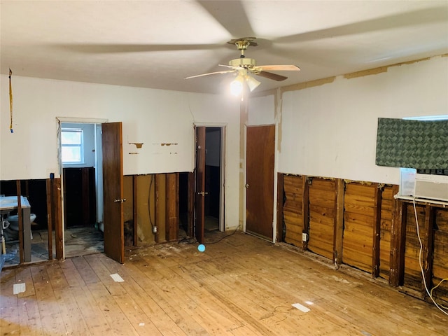 interior space with hardwood / wood-style flooring, ceiling fan, and cooling unit