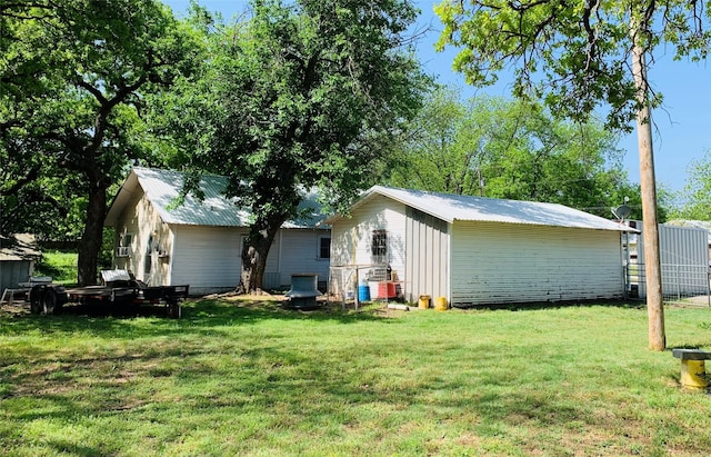 back of property with a lawn and metal roof