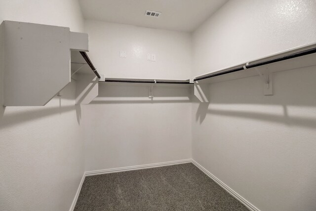walk in closet with carpet floors and visible vents