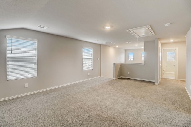 unfurnished room with attic access, light colored carpet, baseboards, visible vents, and recessed lighting