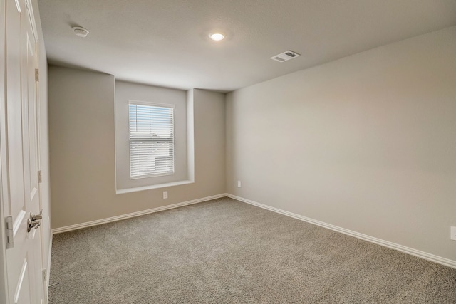 unfurnished room with visible vents, carpet flooring, and baseboards