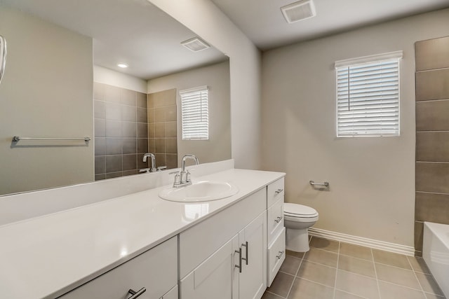 full bath with a bathtub, toilet, baseboards, visible vents, and vanity