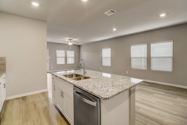 kitchen with stainless steel dishwasher, a sink, light wood-style floors, white cabinets, and visible vents