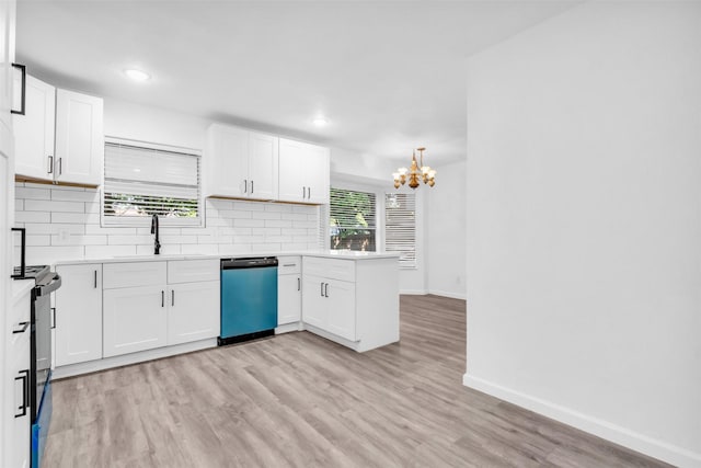 kitchen with a sink, an inviting chandelier, baseboards, a peninsula, and dishwashing machine