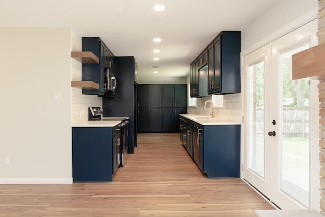 kitchen featuring light wood-style floors, tasteful backsplash, open shelves, and blue cabinets