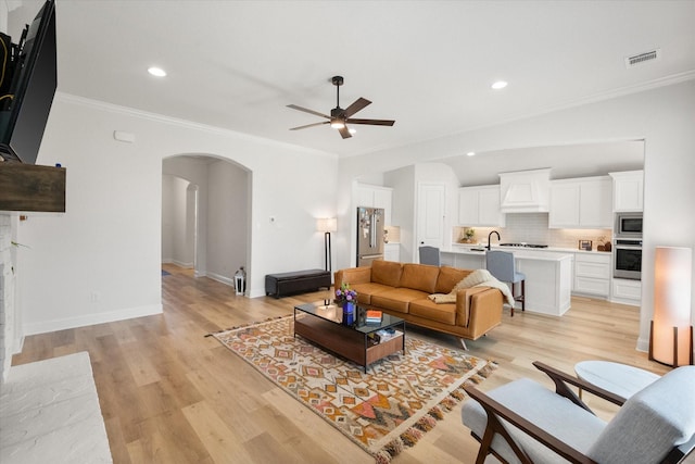 1503 Evening Primrose Dr, Mansfield, TX 76063 - living area with arched walkways, a ceiling fan, light wood-style flooring, crown molding, and recessed lighting