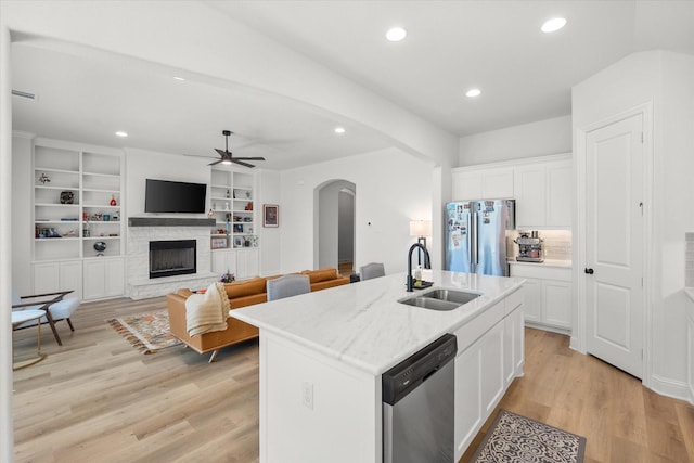 1503 Evening Primrose Dr, Mansfield, TX 76063 - kitchen with stainless steel appliances, a sink, arched walkways, ceiling fan, and recessed lighting